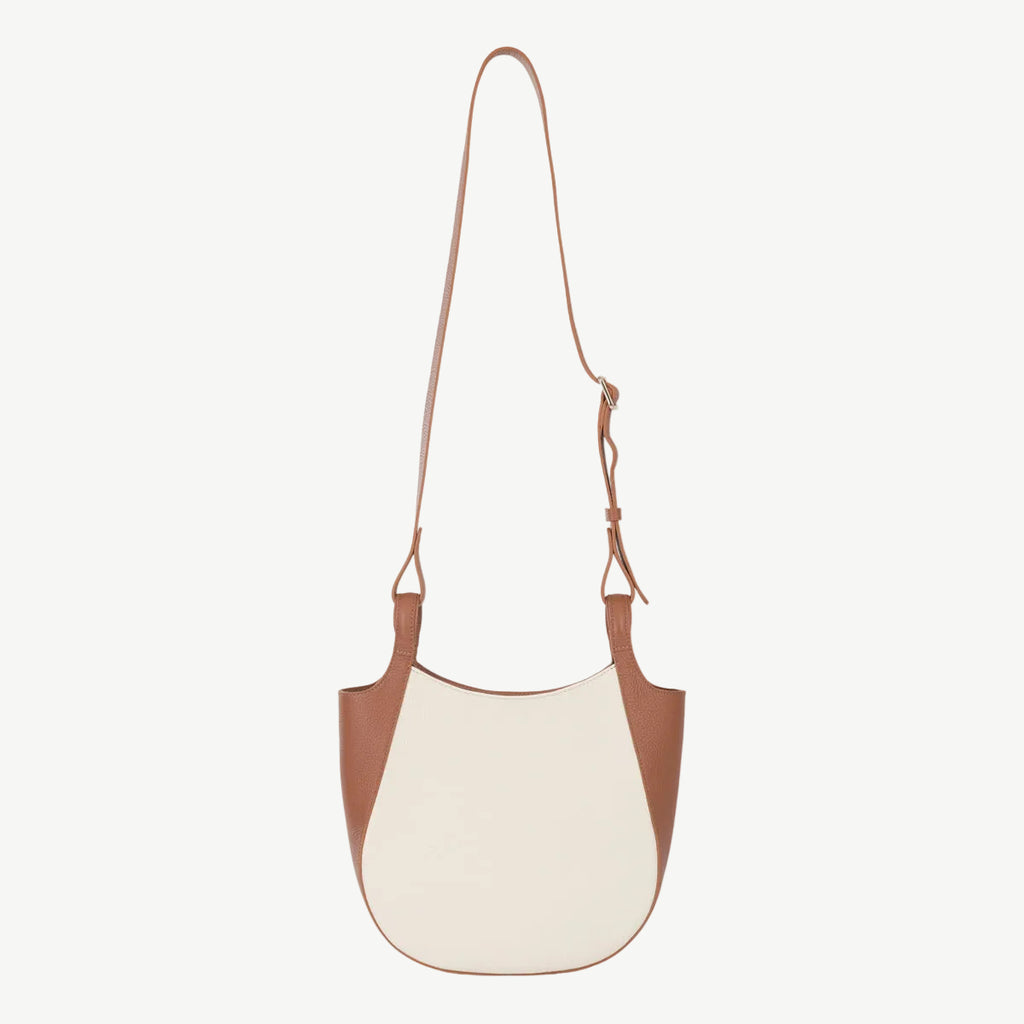 Two-tone brown and white handbag on a white background